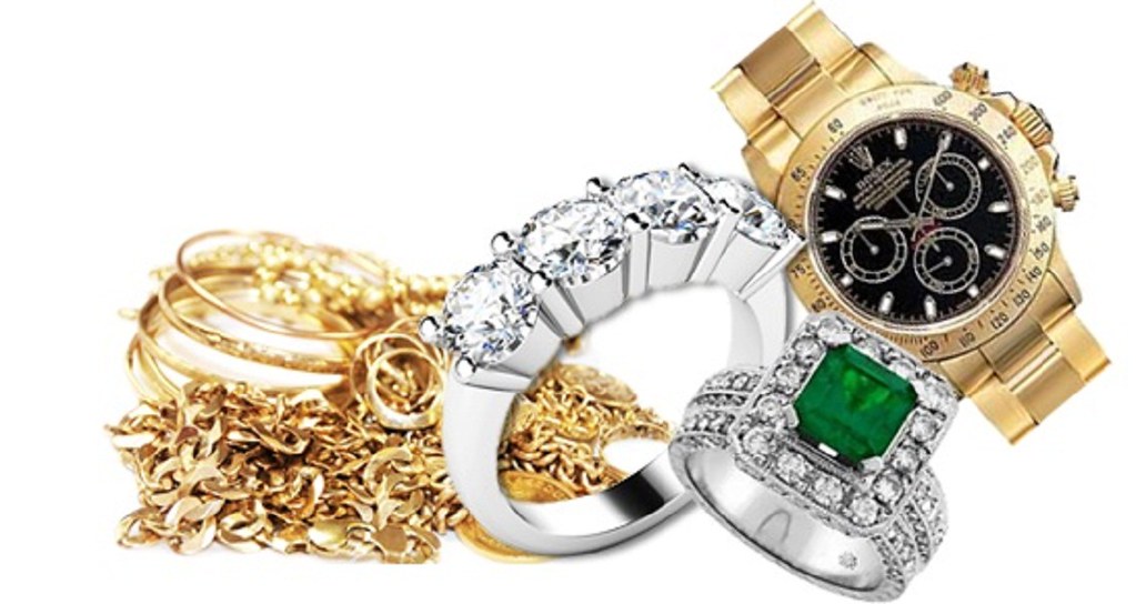 inherited jewelry with gold rings, gold chain, silver wedding band, silver engagement ring, emerald stone with diamonds ring and antique Rolex watch