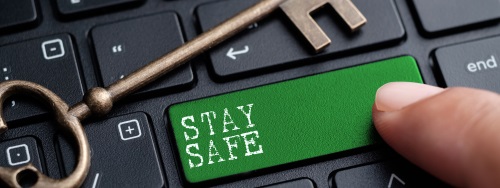 image of a computer keyboard in black with a green button that reads stay safe